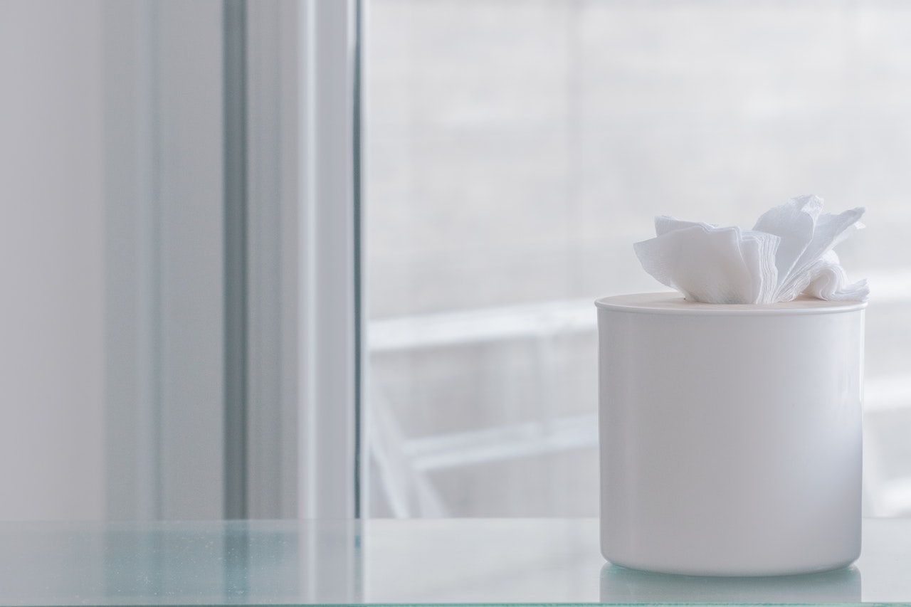 tissue-paper-on-container-near-glass-window-2292081